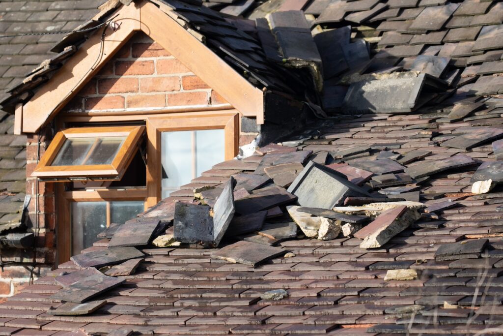 Roof damaged with crumbling shingles.