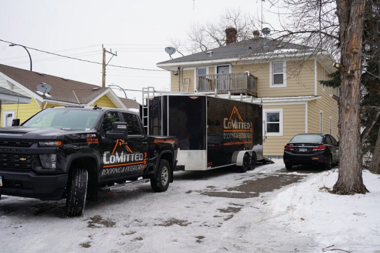 The CoMitted365 truck outside of a yellow home in Winter