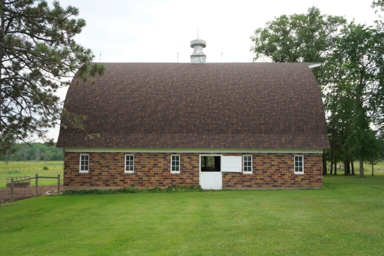 Side view of a barn displaying its new roof