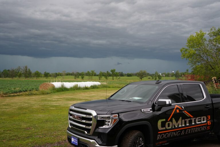 A storm approaches behind a CoMitted365 Truck