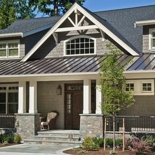 Trendy home with a metal section of roof on their mostly asphalt shingle roofed home