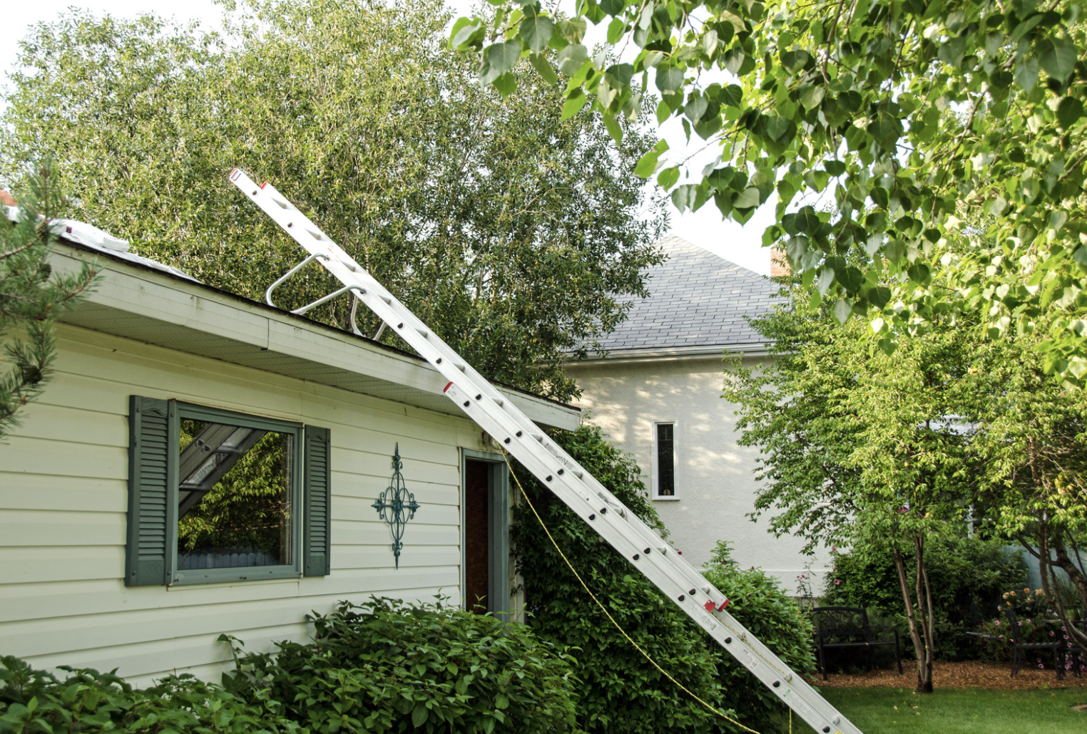 Ladder leading onto a one-story home's roof