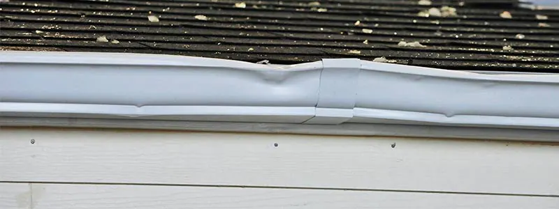 Hail-damaged roof shingles with dents inspected by Committed 365 Roofing & Exteriors