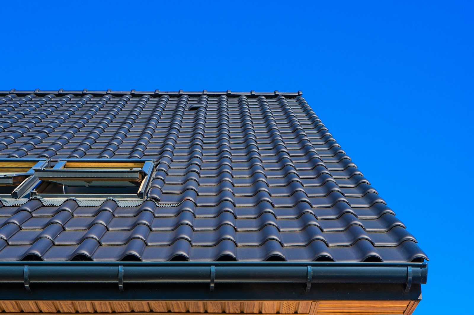 Neatly aligned black roof tiles on a home