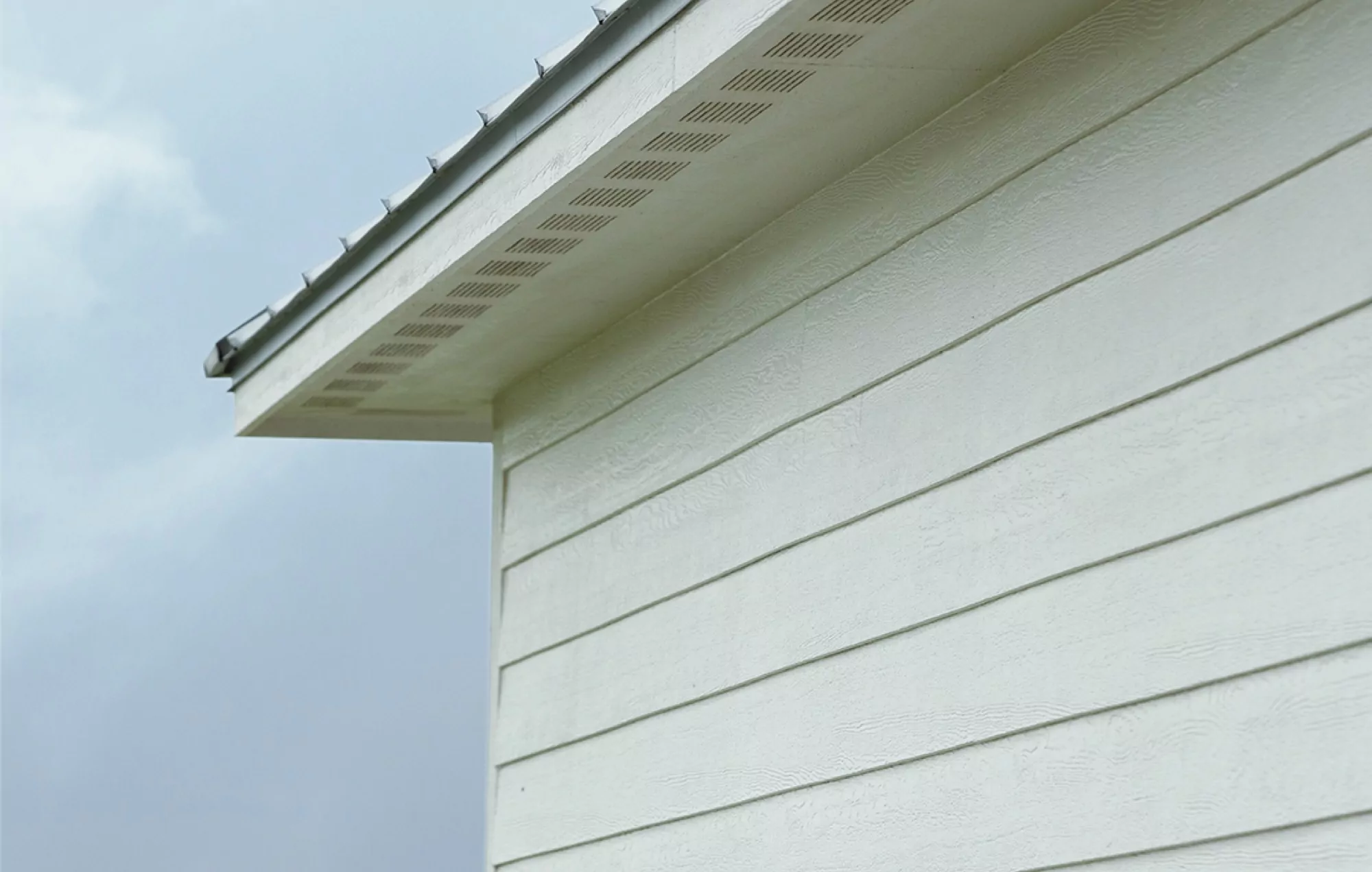 Gutters along a white home's roof