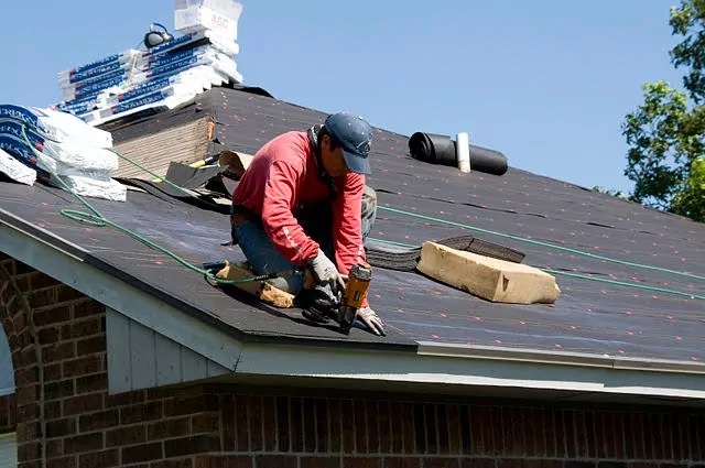 Roofer installing a home's roofing