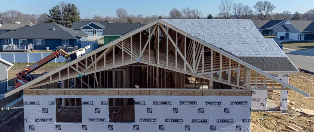 Under-construction home having its rooftop installed