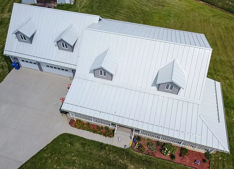 White metal roof atop a home in the countryside