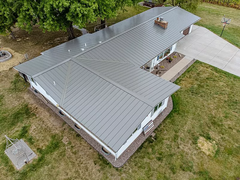 Aerial view over a home's standing seam metal roof