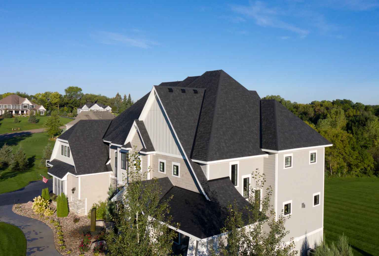 Aerial view of a home featuring asphalt shingle roofing installed by Committed Roofing & Exteriors.