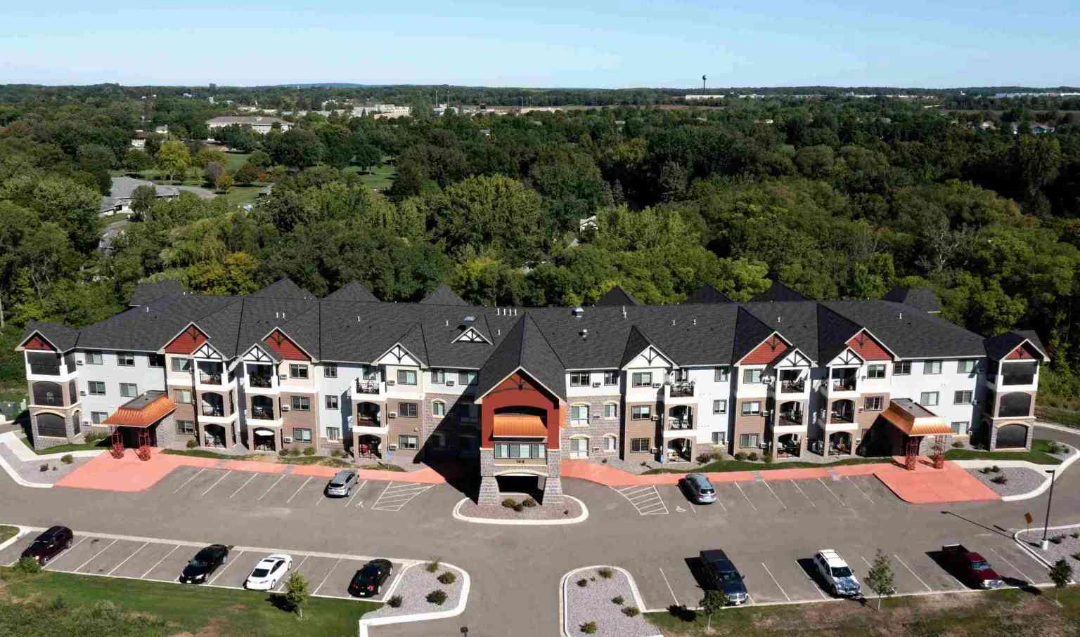 Commercial roofing services by Committed Roofing & Exteriors on a large multi‑unit building.