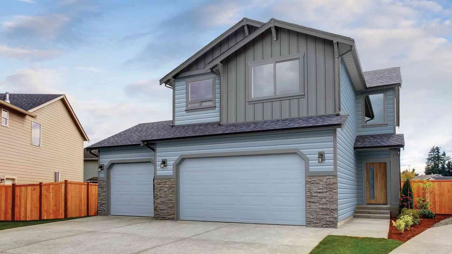 Residential home with professionally installed vinyl siding by Committed Roofing & Exteriors.