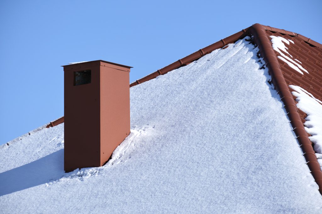 snow covered red roof on a sunny winter day 2026 03 17 05 53 35 utc