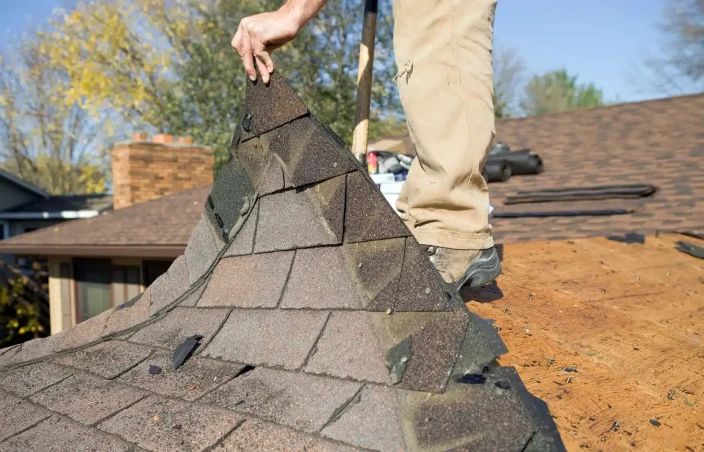 Roofing contractors inspecting a roof for repair or replacement needs inHow to Tell if You Need Roof Repair vs Replacement