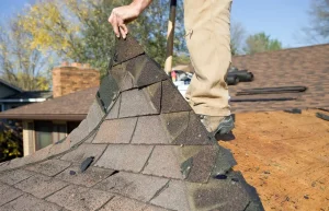 Roofing contractors inspecting a roof for repair or replacement needs inHow to Tell if You Need Roof Repair vs Replacement